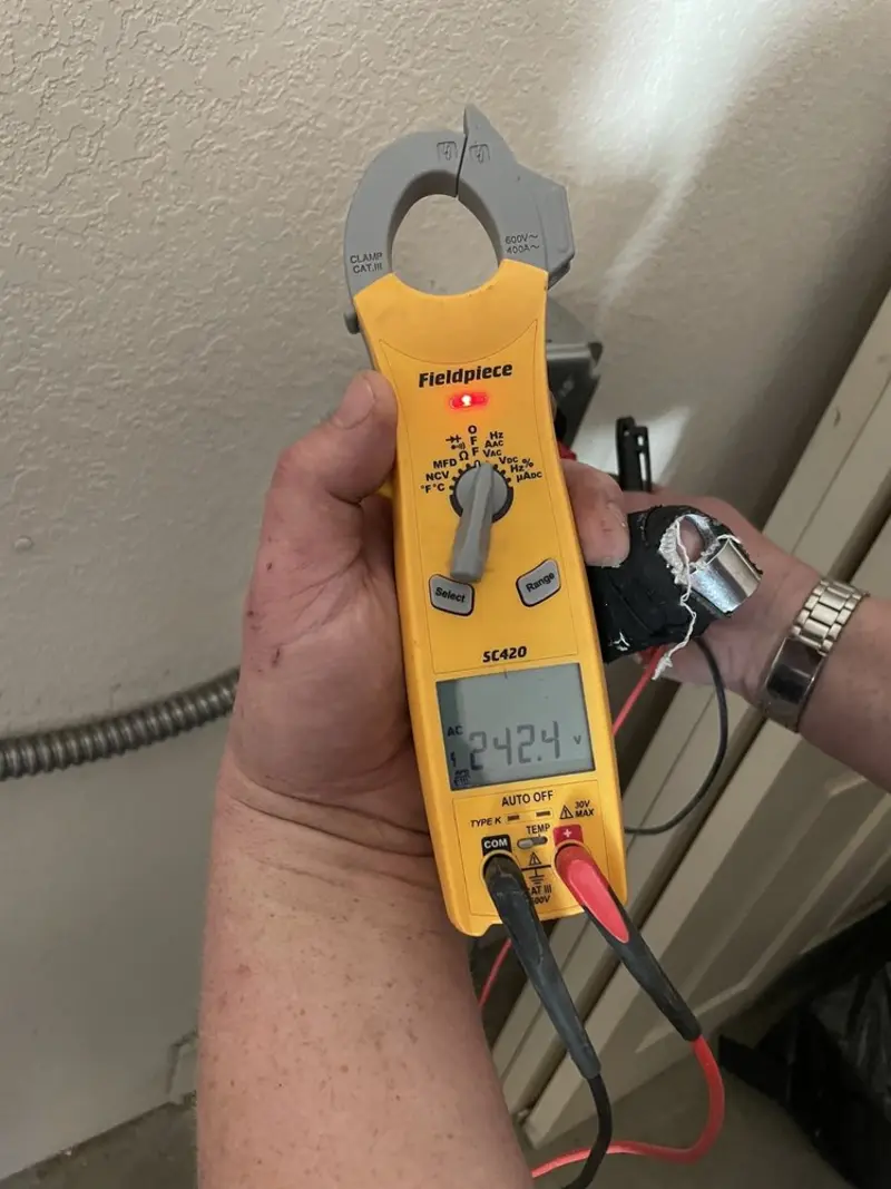 Voltage testing with clamp meter during Ceiling Fan Installation in Kenner